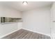 A dining area features hardwood floors, an overhead light, a breakfast bar, and electrical outlets at 1600 Sharon W Rd # 11, Charlotte, NC 28210