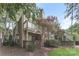 The exterior of this home includes a small yard, patio area, a lovely tree, and a chimney at 1600 Sharon W Rd # 11, Charlotte, NC 28210