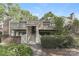 Charming two-story townhouse featuring well-maintained landscaping, and a private entrance with stairs and a deck at 1600 Sharon W Rd # 11, Charlotte, NC 28210