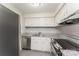 This kitchen is updated with stainless steel appliances, white cabinets, and granite countertops at 1600 Sharon W Rd # 11, Charlotte, NC 28210