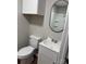 Updated bathroom with new vanity, toilet, and mirror at 702 N 9Th St, Bessemer City, NC 28016