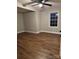 Bright and airy bedroom featuring hardwood floors, a ceiling fan, and a large window at 702 N 9Th St, Bessemer City, NC 28016