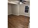 Spacious bedroom featuring hardwood floors, a ceiling fan, and natural light from a window at 702 N 9Th St, Bessemer City, NC 28016