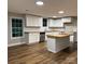 Bright kitchen features white cabinets, butcher block counters, stainless appliances, and subway tile backsplash at 702 N 9Th St, Bessemer City, NC 28016