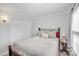 Full-size bed in bright bedroom with double door closet at 5003 Sharon Rd # L, Charlotte, NC 28210