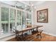 Bright dining area with farmhouse table and plantation shutters at 120 Holly Branch Ln, Troutman, NC 28166