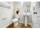 Clean and modern bathroom with pedestal sink and white toilet at 5104 Carrick St, Charlotte, NC 28213