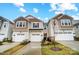 Townhome exterior boasts a modern design with attached garages at 5104 Carrick St, Charlotte, NC 28213