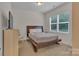 Cozy bedroom with a wooden bed frame and large window at 5267 Norway Ln, Rock Hill, SC 29732