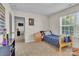 Well-lit bedroom with a twin bed, dresser, and window at 5267 Norway Ln, Rock Hill, SC 29732