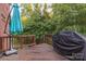 Wooden deck with covered grill and blue umbrella at 5267 Norway Ln, Rock Hill, SC 29732