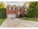 Two-story brick home with a large driveway and mature trees at 5267 Norway Ln, Rock Hill, SC 29732