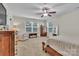 Main bedroom with a king-size bed, seating area and large windows at 5267 Norway Ln, Rock Hill, SC 29732