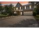 Evening view of a two-story home with stone and siding at 4043 Orchid Way, Tega Cay, SC 29708