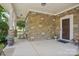 Stone front porch with seating and decorative planters at 4043 Orchid Way, Tega Cay, SC 29708