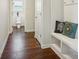 Hallway with built-in bench seating and hardwood floors at 4043 Orchid Way, Tega Cay, SC 29708