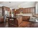 Kitchen with island, dark wood cabinets, and granite countertops at 4043 Orchid Way, Tega Cay, SC 29708