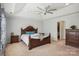 Main bedroom with a large bed, ceiling fan, and access to closet at 4043 Orchid Way, Tega Cay, SC 29708