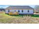 View of the backyard with a small deck overlooking the grassy area and the gray exterior of the house at 6217 Long Branch Rd, Salisbury, NC 28147