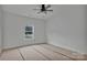 Bright bedroom featuring a window overlooking the greenery outside and unfinished flooring at 6217 Long Branch Rd, Salisbury, NC 28147