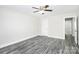 Neutral bedroom features gray tone wood flooring, a ceiling fan, and a doorway at 6217 Long Branch Rd, Salisbury, NC 28147