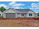 New construction home featuring light gray siding, a two-car garage, and a classic roof design at 6217 Long Branch Rd, Salisbury, NC 28147