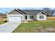 Charming one-story home with white siding, attached garage, and a well-manicured front lawn at 6217 Long Branch Rd, Salisbury, NC 28147