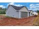New construction home featuring a two-car garage and light blue vinyl siding at 6217 Long Branch Rd, Salisbury, NC 28147