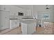 Bright kitchen with white cabinets, stainless steel appliances, gray granite countertops, and open floor plan at 6217 Long Branch Rd, Salisbury, NC 28147