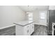 Kitchen island with granite countertops, white cabinets, and stainless steel appliances at 6217 Long Branch Rd, Salisbury, NC 28147