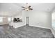 Open-concept living area with vaulted ceilings, gray flooring, and a view into the adjacent kitchen at 6217 Long Branch Rd, Salisbury, NC 28147