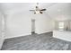 Bright living room features a vaulted ceiling, gray laminate flooring, and a modern ceiling fan at 6217 Long Branch Rd, Salisbury, NC 28147