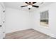 A cozy bedroom with a ceiling fan, window, and light wood-look floors at 6259 Long Branch Rd, Salisbury, NC 28147