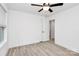 A bright bedroom with a ceiling fan, windows, and light wood-look floors at 6259 Long Branch Rd, Salisbury, NC 28147