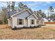 Exterior view of the home with attractive landscaping, vinyl siding, and a new driveway at 6259 Long Branch Rd, Salisbury, NC 28147