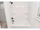 A clean white tub shower with black hardware and built-in shelves at 6259 Long Branch Rd, Salisbury, NC 28147