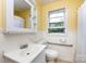 Clean bathroom with white fixtures, a large mirror, and a window for natural light at 2001 Mcdonald Dr, Charlotte, NC 28216