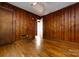 Cozy bedroom featuring hardwood floors and paneled walls at 2001 Mcdonald Dr, Charlotte, NC 28216