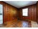 Spacious room featuring hardwood floors, natural light, and paneled walls at 2001 Mcdonald Dr, Charlotte, NC 28216