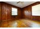 Bright bedroom with hardwood floors and paneled walls, featuring natural lighting at 2001 Mcdonald Dr, Charlotte, NC 28216