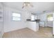 Bright kitchen with white cabinets, tile countertops, an electric range, and ceiling fan at 2001 Mcdonald Dr, Charlotte, NC 28216