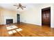 Inviting living room featuring a fireplace, ceiling fan, and gleaming hardwood floors at 2001 Mcdonald Dr, Charlotte, NC 28216