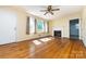 Hardwood floors, a fireplace, ceiling fan, and many windows make this living room bright and airy at 2001 Mcdonald Dr, Charlotte, NC 28216