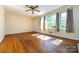 Bright living room features hardwood floors, a ceiling fan, and bright natural light at 2001 Mcdonald Dr, Charlotte, NC 28216