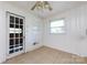 Charming room featuring a bright window, built-in shelving, and linoleum flooring at 2001 Mcdonald Dr, Charlotte, NC 28216