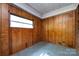 Cozy room featuring paneled walls, a window, and durable flooring at 2001 Mcdonald Dr, Charlotte, NC 28216