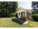 Charming sun room addition with brick base and lots of natural light shining onto the lawn at 2001 Mcdonald Dr, Charlotte, NC 28216