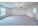 Spacious bonus room with carpeted floor and ceiling fan at 2613 Plyler Mill Rd, Monroe, NC 28112