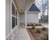 Front porch with stone accents and landscaping in front of a two-story house at 2613 Plyler Mill Rd, Monroe, NC 28112