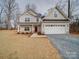 Two-story house with front yard, attached garage, and stone accents at 2613 Plyler Mill Rd, Monroe, NC 28112